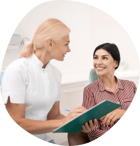 Woman talking to medical professional with clipboard