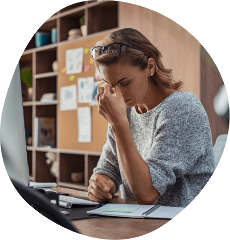 Businesswoman struggling to stay awake while sitting at desk