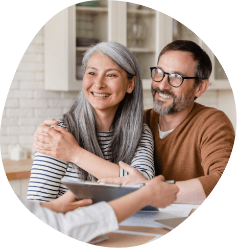 Man and woman sitting across desk from someone with a tablet