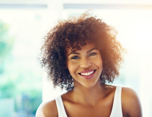 Smiling woman wearing white tank top