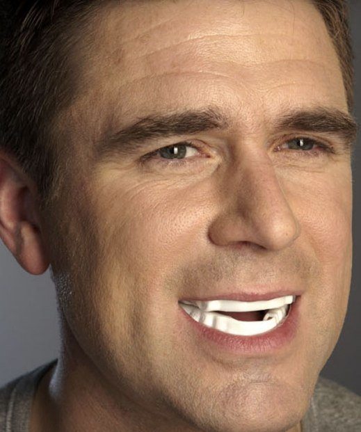 Man wearing a white oral appliance in Irving over his teeth