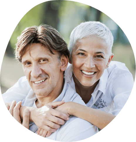 Senior man and woman embracing outdoors