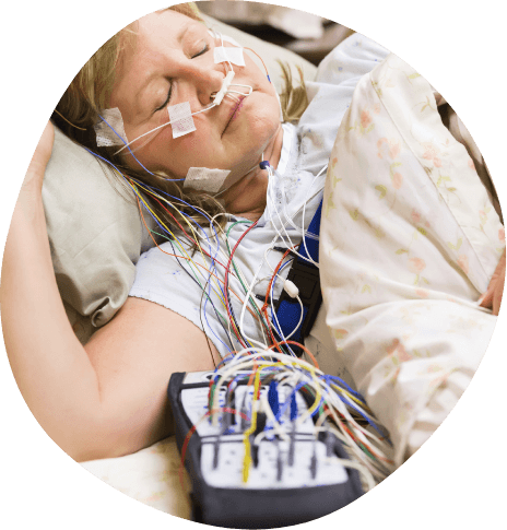 Woman wearing electrodes on her face for sleep apnea test