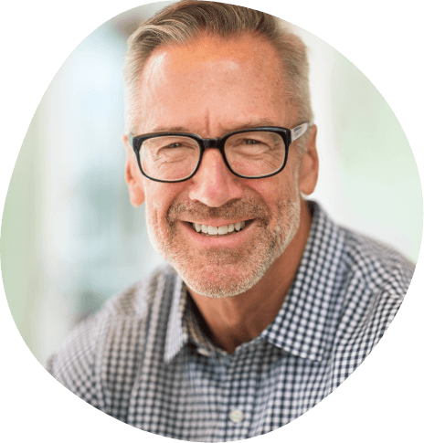 Smiling man with glasses and a plaid shirt