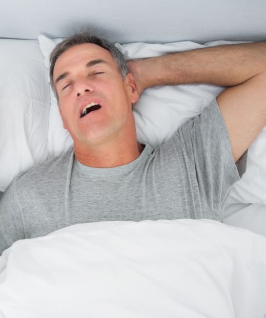 Man sleeping with mouth open needing snoring treatment in Irving