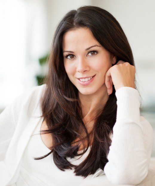 Thin brunette woman smiling after weight loss treatment for sleep apnea in Irving