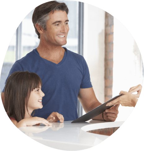 Man with his young daughter smiling at front desk team member