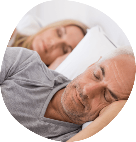 Senior man and woman peacefully sleeping next to each other