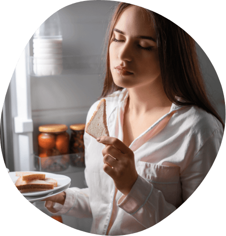 Woman eating bread while sleeping