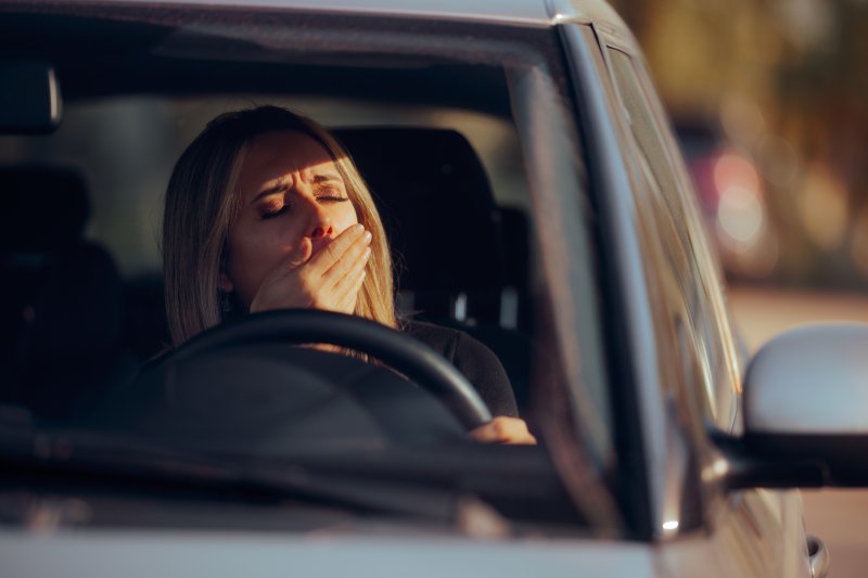 woman feeling tired while driving